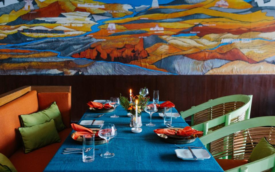 Colourful artwork and furnishings in the dining room at Shinta Mani Mustang
