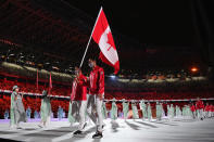 <p>TOKYO, JAPAN - JULY 23: Flag bearers Miranda Ayim and Nathan Hirayama of Team Canada lead their team during the Opening Ceremony of the Tokyo 2020 Olympic Games at Olympic Stadium on July 23, 2021 in Tokyo, Japan. (Photo by Matthias Hangst/Getty Images)</p> 