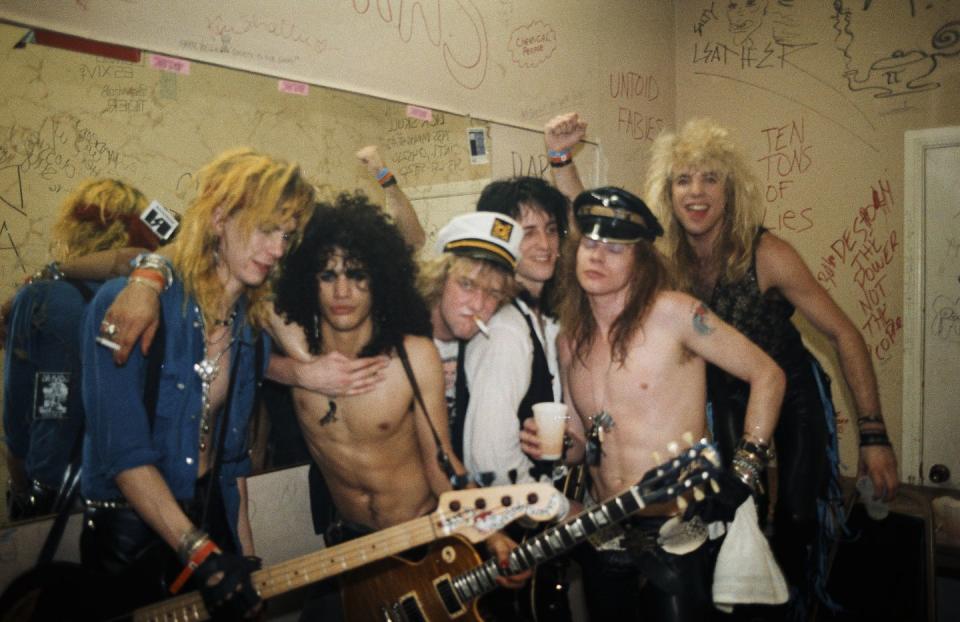 <p>The members of Guns N' Roses, Duff McKagan, Slash, Izzy Stradlin, Axl Rose, and Steven Adler, party backstage at the Fenders Ballroom in Long Beach, California in 1986. Shortly after this gig, the band was signed by Geffen Records. </p>