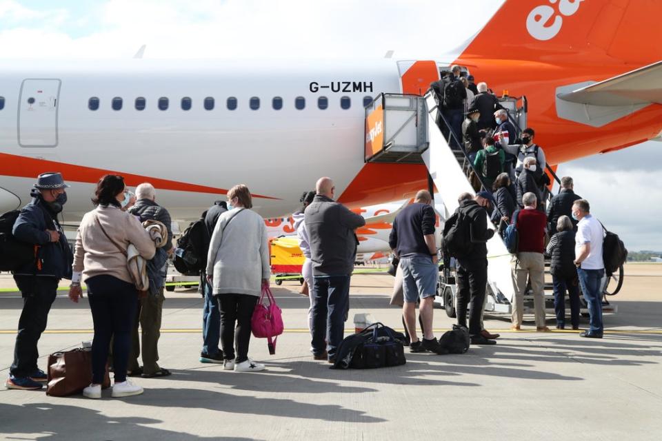 Passengers board an easyJet plane (PA Wire)