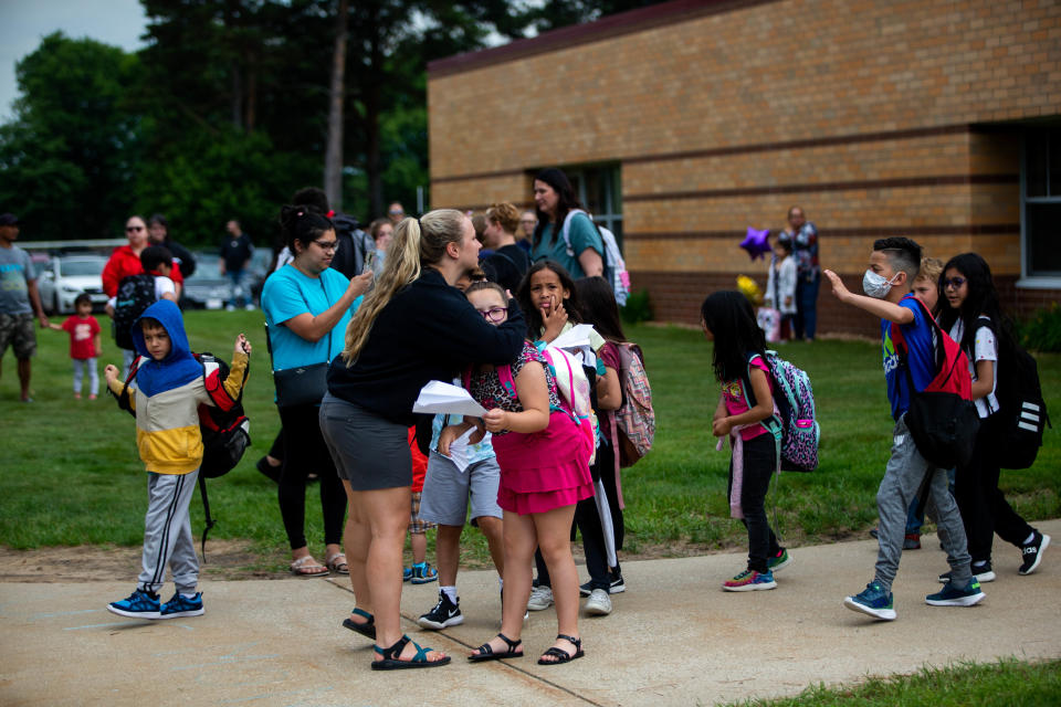 Students hug their teachers as they say goodbye during the last day of school for West Ottawa Great Lakes Elementary Friday, June 10, 2022, in Holland. Great Lakes will be one of the stops for the West Ottawa Bookmobile each Tuesday this summer.