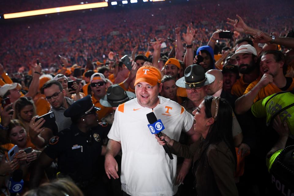 Tennessee head coach Josh Heupel is swarmed by fans storming the field after Tennessee defeated Alabama 52-49 in Neyland Stadium, Saturday, Oct. 15, 2022.