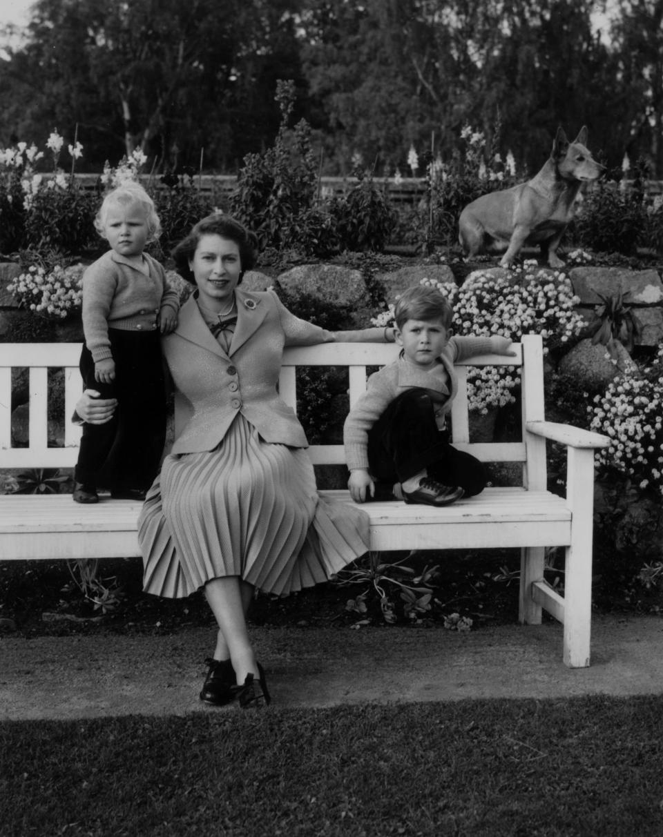 Queen Elizabeth (center), King Charles (right), and Princess Anne in Balmoral Castle gardens circa 1952.