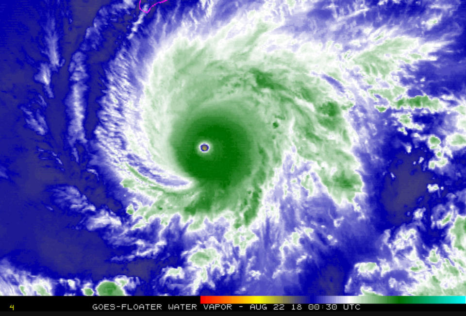 This NASA satellite imagery shows Hurricane Lane in the Central Pacific Ocean southeast of the Hawaiian Islands Tuesday, Aug. 21, 2018. South Point on the Big Island of Hawaii is outlined at top left. Hawaii residents rushed to grocery stores Tuesday to stock up on bottled water, ramen and toilet paper as they faced the threat of heavy rain, flash flooding and high surf from the powerful and erratic hurricane expected to churn close to the islands or directly over them. The National Weather Service issued a hurricane watch for Hawaii, Maui and other smaller islands, meaning tropical storm-force winds, excessive rain and large swells could arrive starting Wednesday. (NASA via AP)