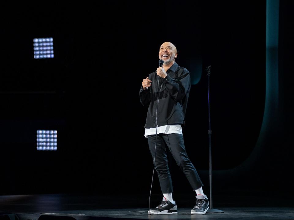 Jo Koy onstage in "Live from the Los Angeles Forum" on Netflix.