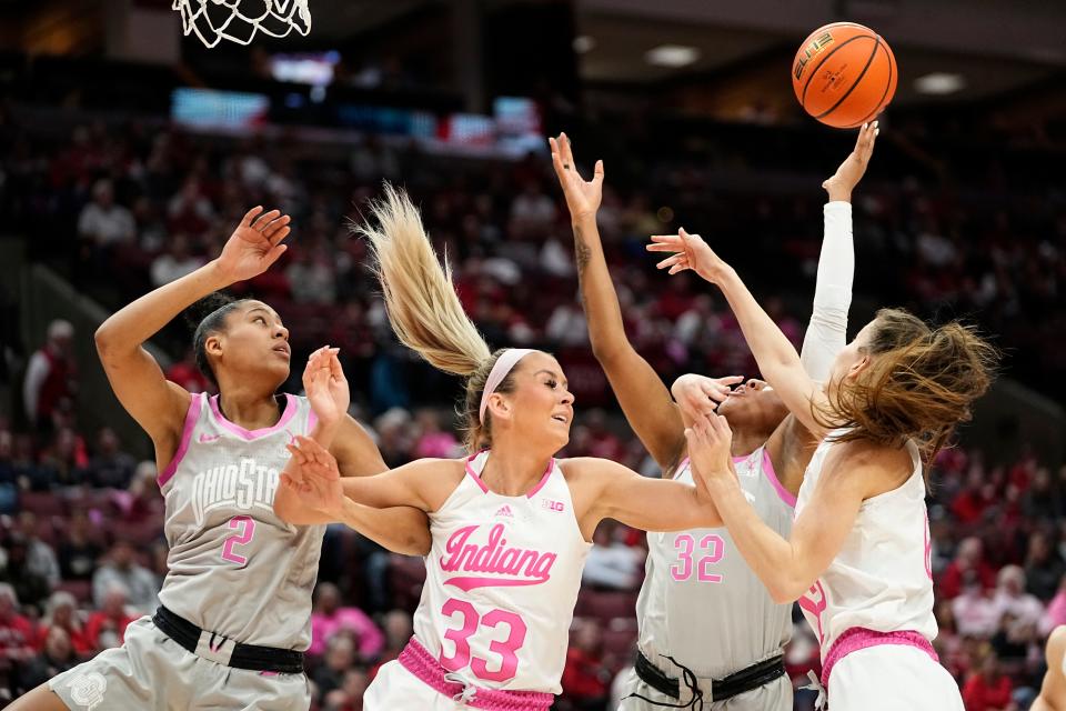 Ohio State forward Cotie McMahon (32) reaches for a rebound between Indiana's Yarden Garzon (12) and Sydney Parrish and Ohio State's Taylor Thierry.