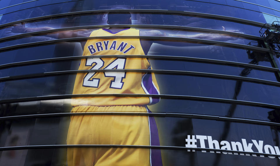 FILE - In this April 13, 2016 file photo a giant banner congratulating Kobe Bryant is draped around Staples Center before his last NBA basketball game, a contest against the Utah Jazz, in downtown Los Angeles. Bryant, a five-time NBA champion and a two-time Olympic gold medalist, died in a helicopter crash in California on Sunday, Jan. 26, 2020. He was 41. (AP Photo/Richard Vogel, file)