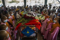 Buddhist nuns surround the casket of Pho Chit, an anti-coup protester who died during a Mar. 3 rally, during his funeral in Yangon, Myanmar Friday, Mar. 5, 2021. Demonstrators defy growing violence by security forces and stage more anti-coup protests ahead of a special U.N. Security Council meeting on the country's political crisis. (AP Photo)