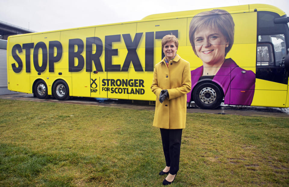 Scottish National Party (SNP) leader Nicola Sturgeon launches the party's election campaign bus, featuring a portrait of herself, at Port Edgar Marina in the town of South Queensferry, Scotland, before setting off on a tour of Scotland for the final week of the SNP's General Election campaign, Thursday Dec. 5, 2019.  Britain's Brexit is one of the main issues for all political parties and for voters, as the UK goes to the polls in a General Election on Dec. 12. (Jane Barlow/PA via AP)