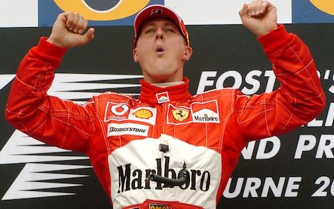 Michael Schumacher celebrating a race victory - Credit: AP