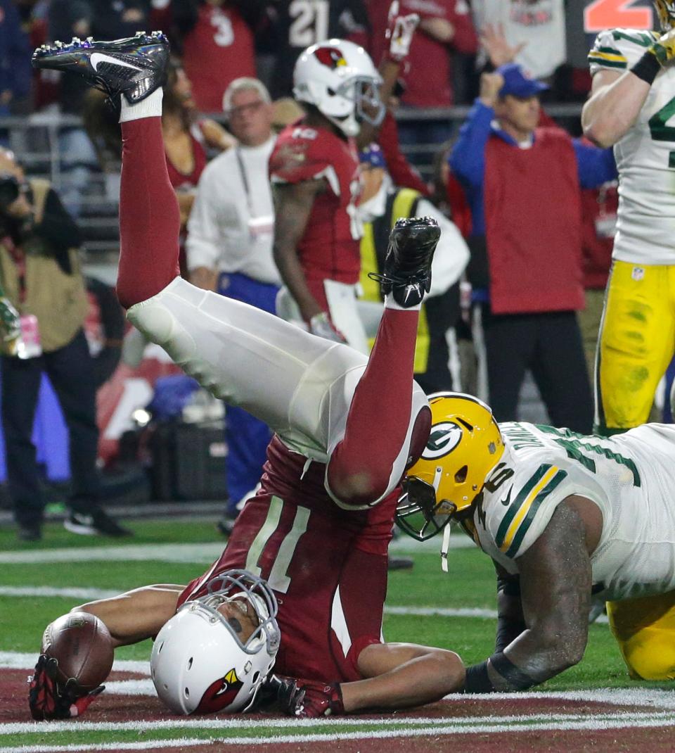 Arizona Cardinals wide receiver Larry Fitzgerald (11) scores the game-winning touchdown in overtime of their divisional playoff game Saturday, June 16, 2016 at the the University of Phoenix Stadium in Glendale, Arizona. The Arizona Cardinals beat the Green Bay Packers in overtime 26-20.