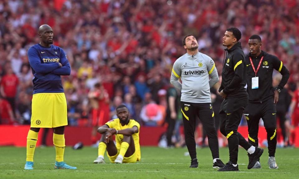 Chelsea players and staff struggle to hide their disappointment as Liverpool collect their winners’ medals