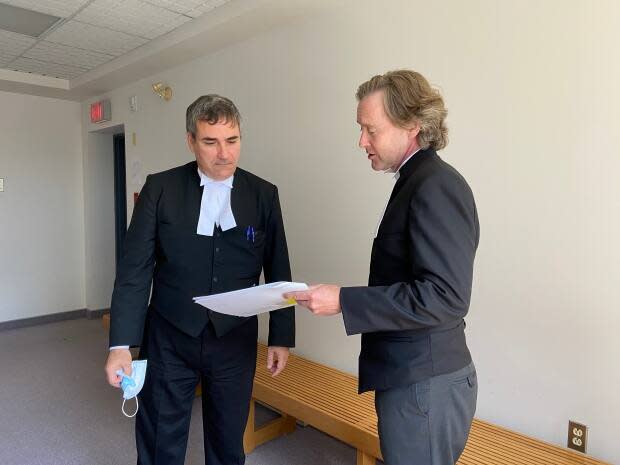 Crown prosecutors Constantin Draghici-Vasilescu and Mark Donohue are shown during a break in the Nova Scotia Supreme Court trial that is taking place in Sydney. (Erin Pottie/CBC - image credit)