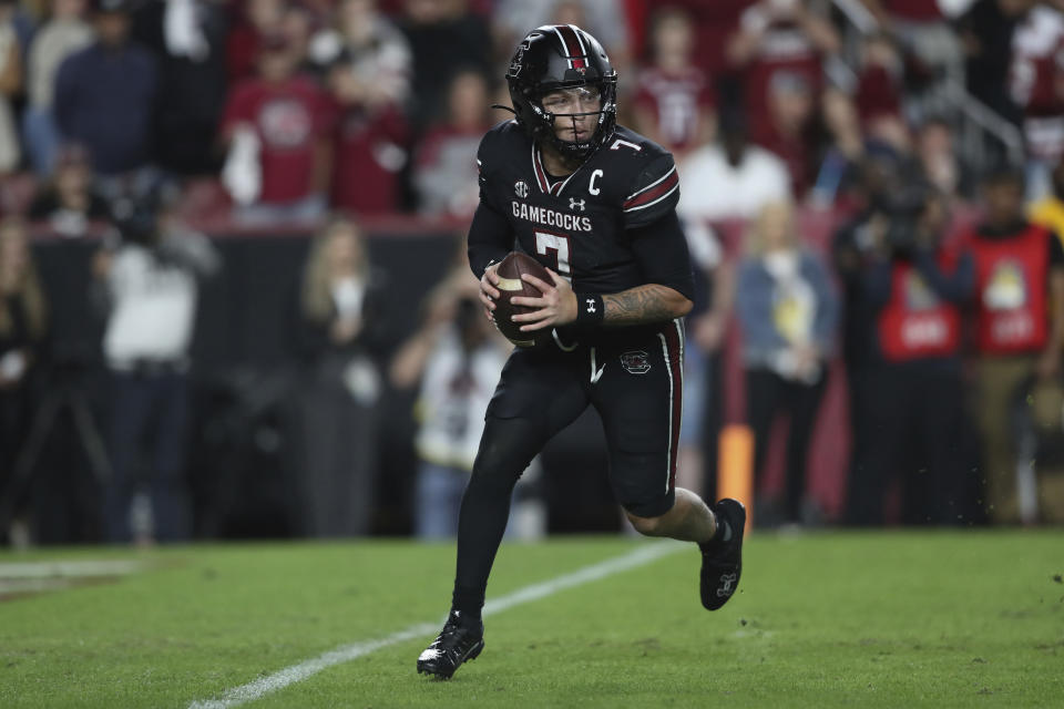 South Carolina quarterback Spencer Rattler (7) rolls out to pass during the second half of the team's NCAA college football game against Kentucky on Saturday, Nov. 18, 2023, in Columbia, S.C. (AP Photo/Artie Walker Jr.)