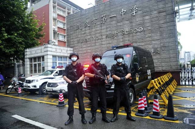 Armed police stand guard outside a testing site for China’s national college entrance examinations, also known as the gaokao, in Wuhan in central China’s Hubei Province (AP)