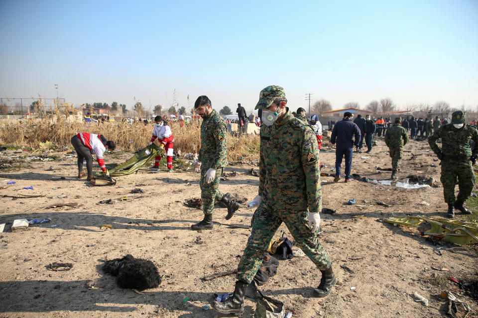 Security officers are seen at the site where the Ukraine International Airlines plane crashed after take-off from Iran's Imam Khomeini airport, on the outskirts of Tehran, Iran January 8, 2020. Nazanin Tabatabaee/WANA (West Asia News Agency) via REUTERS