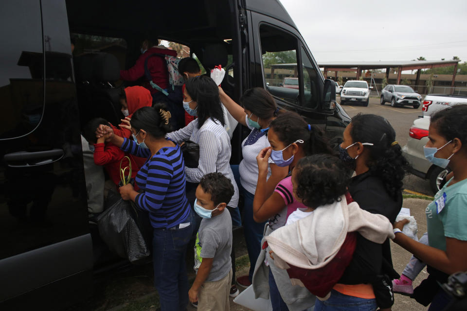 CORRECTS CITY TO MISSION FROM MCALLEN - Migrants board a van at Our Lady of Guadalupe Catholic Church in Mission, Texas, on Palm Sunday, March 28, 2021. U.S. authorities are releasing migrant families at the border without notices to appear in immigration court and sometimes, without any paperwork at all. (AP Photo/Dario Lopez-Mills)