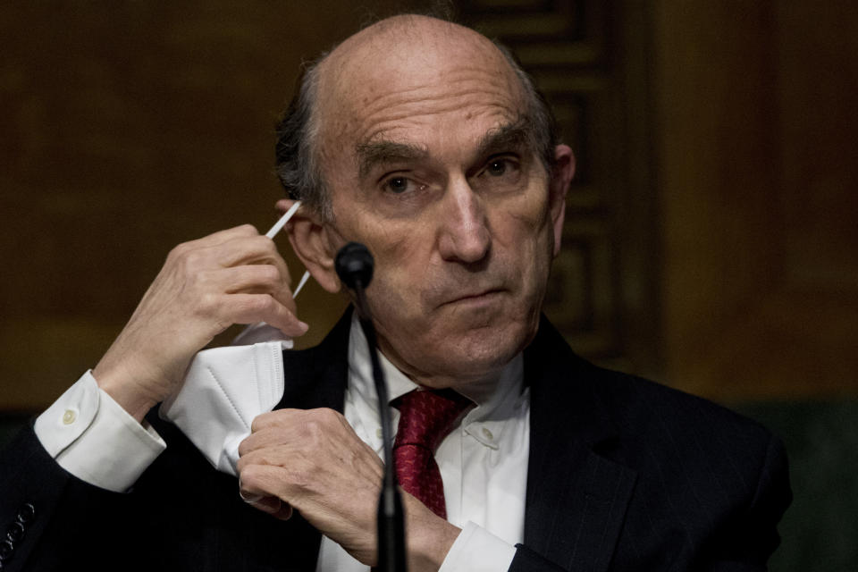 State Department Special Representative for Venezuela Ambassador Elliott Abrams takes off his mask to testify at a Senate Foreign Relations Committee hearing on Capitol Hill in Washington, Tuesday, Aug. 4, 2020. (AP Photo/Andrew Harnik)