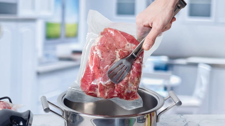 meat being placed in sous vide