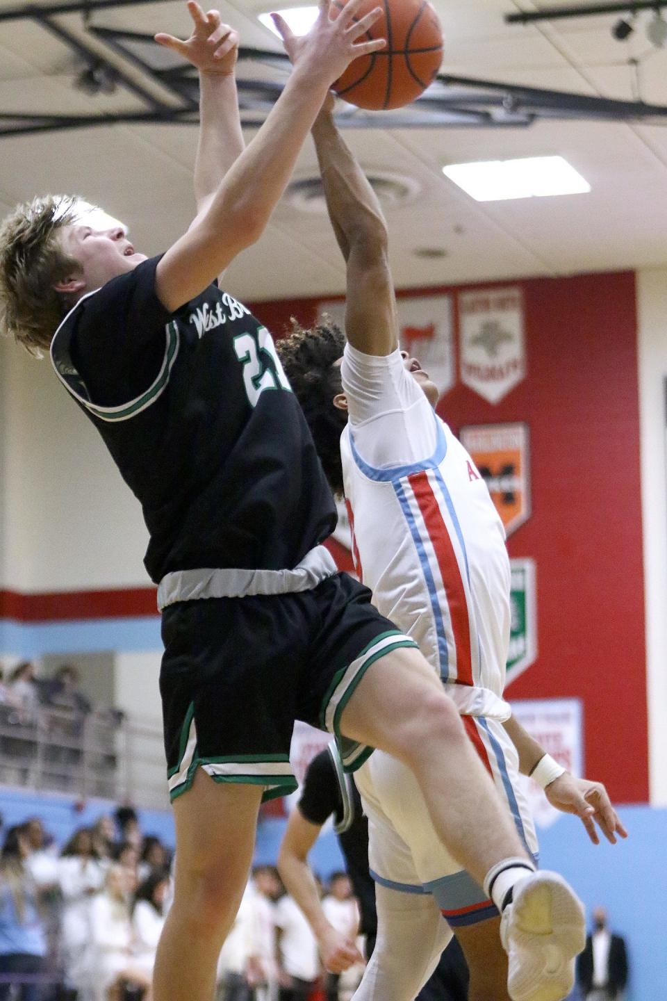 West Branch's Joey Jackson, left, and Alliance's Gage Ford going for a rebound during action at Alliance High School Tuesday, January 18, 2022.