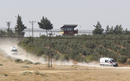 Ambulances leave from the Dag military post, which was attacked by Islamic State militants on Thursday, on the Turkish-Syrian border near Kilis, Turkey, July 24, 2015. REUTERS/Murad Sezer