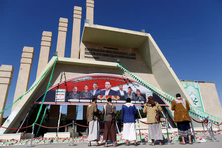 People watch a monument where the former head of the Houthi Supreme Political Council, Saleh al-Sammad, and his body guards are buried after their death during an April 2018 Saudi-led air strike, in Sanaa, Yemen December 12, 2018. REUTERS/Khaled Abdullah