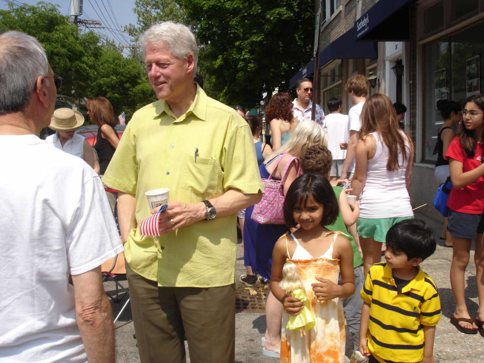 Bill Clinton talks to residents at Memorial Day parade in 2006. The Ramaswamy kids, Sanjana, 5, and Krishna, 3, stand close by.