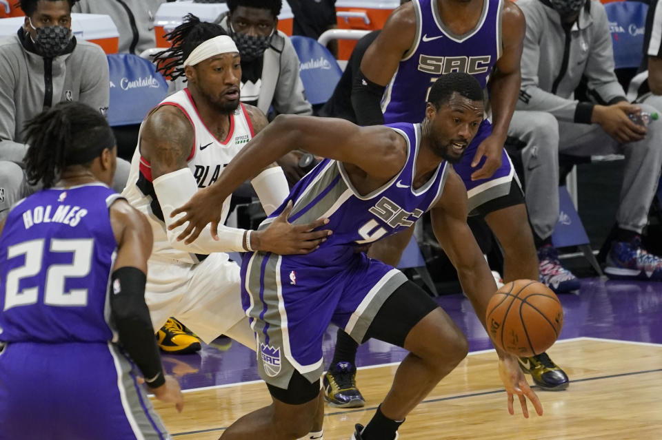 Sacramento Kings forward Harrison Barnes, right, and Portland Trail Blazers forward Robert Covington, second from left, chase after the ball during the first quarter of an NBA basketball game in Sacramento, Calif., Wednesday, Jan. 13, 2021. (AP Photo/Rich Pedroncelli)