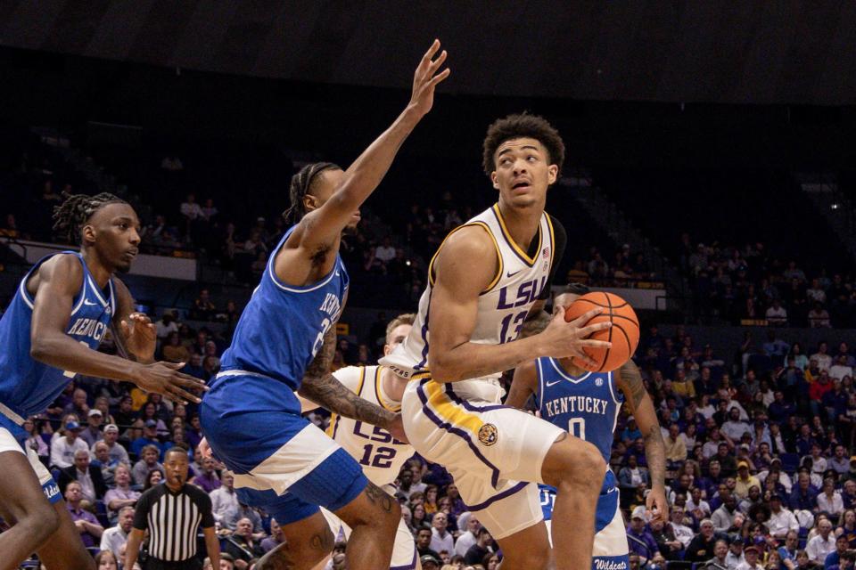 Feb 21, 2024; Baton Rouge, Louisiana, USA; LSU Tigers forward Jalen Reed (13) dribbles against Kentucky Wildcats guard Kareem Watkins (25) during the first half of the game at Pete Maravich Assembly Center. Mandatory Credit: Stephen Lew-USA TODAY Sports