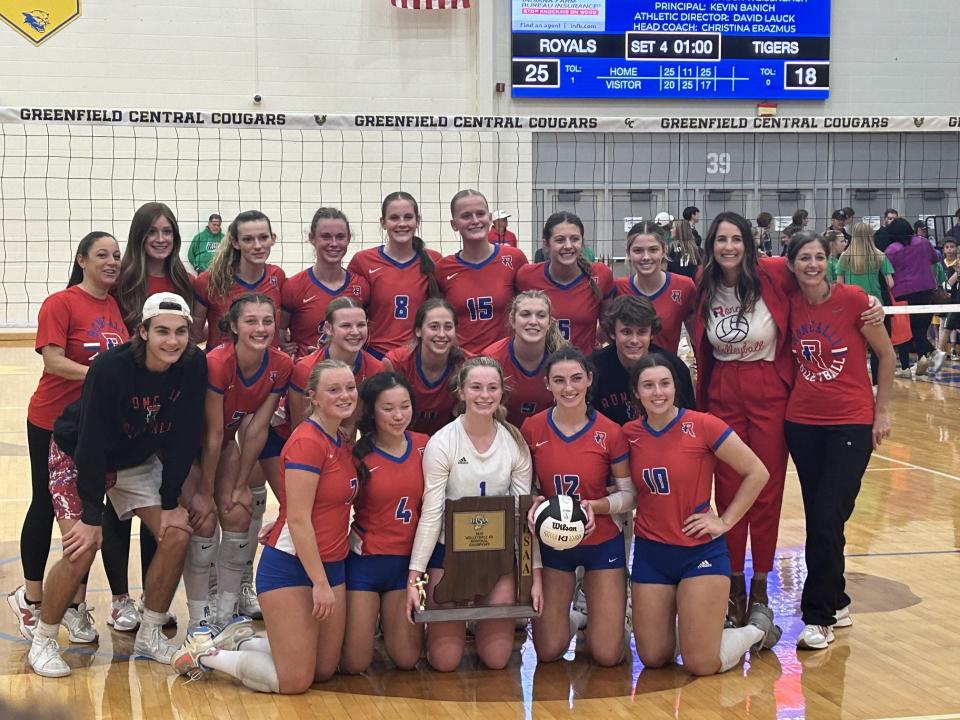 Roncalli girls volleyball poses with the regional championship trophy after beating Yorktown, 3-1, in the regional final.