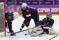 USA goaltender Jonathan Quick blocks a shot on goal by Finland as forward Ryan Kesler seals off the edge of the net during the first period of the men's bronze medal ice hockey game at the 2014 Winter Olympics, Saturday, Feb. 22, 2014, in Sochi, Russia. (AP Photo/Petr David Josek)