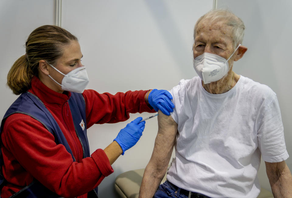 An 87-year-old man receives his booster shot at the vaccination center in Frankfurt, Germany, Thursday, Nov. 11, 2021. Germany’s national disease control center has reported a record-high number of more than 50,000 daily coronavirus cases. The infections spike comes as German lawmakers are mulling new legislation that would pave the way for new coronavirus measures. (AP Photo/Michael Probst)