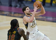 Indiana Pacers' Doug McDermott (20) drives to the basket against Cleveland Cavaliers' Taurean Prince (12) during the second half of an NBA basketball game Wednesday, March 3, 2021, in Cleveland. (AP Photo/Tony Dejak)