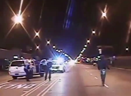 Laquan McDonald (R) walks on a road before he was shot 16 times by police officer Jason Van Dyke in Chicago, in this still image taken from a police vehicle dash camera video shot on October 20, 2014, and released by Chicago Police on November 24, 2015. REUTERS/Chicago Police Department/Handout via Reuters