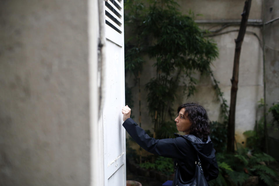 In this Friday, Sept. 21, 2018 photo, an inspector of Paris' town hall in charge of checking locations for tourists makes a door to door inspection, in Paris. The spectacular growth of Airbnb in Paris, the top worldwide location for the internet giant is also raising alarms in the French capital. Some Parisians and officials at City Hall blame the site for driving Parisian families out of the city center, leading to school closures and concerns that the French capital is losing its life and charms. (AP Photo/Thibault Camus)