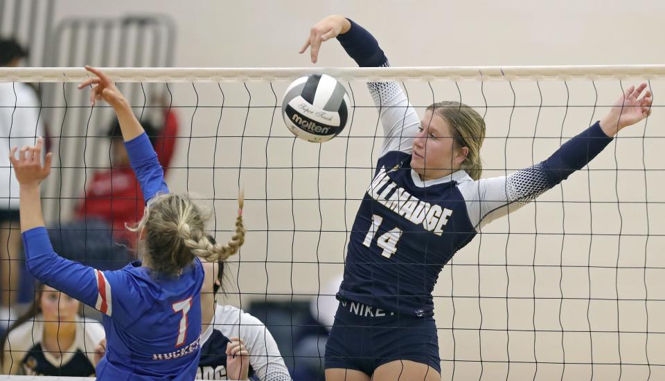 Tallmadge senior Zoe Rensel hits the ball over the net against Bay senior Kristina Laraway during the second set of a Division II district semifinal volleyball match, Wednesday, Oct. 26, 2022, in Tallmadge, Ohio.