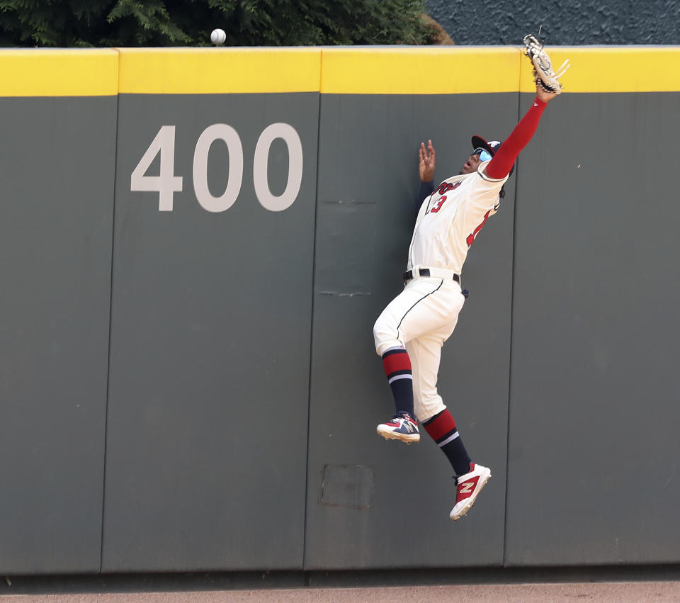 Atlanta Braves outfielder Ronald Acuna Jr. cannot hold on to a three-run home run by Los Angeles Dodgers' Cody Bellinger during the first inning of a baseball game Sunday, Aug. 18, 2019, in Atlanta. (Curtis Compton/Atlanta Journal-Constitution via AP)