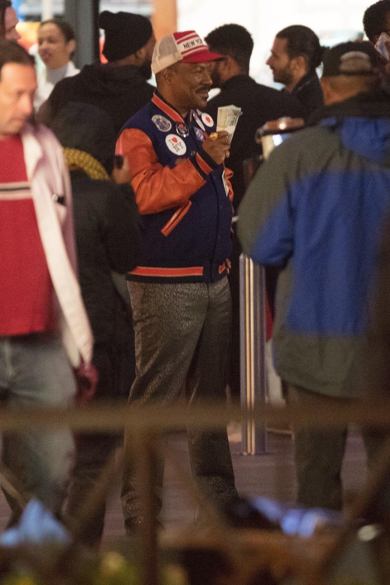 Eddie Murphy pictured on set filming scenes for "Coming 2 America" in Atlanta, Ga. on Nov. 2, 2019. Prince Akeem seems to be a Mets fan scalping tickets!