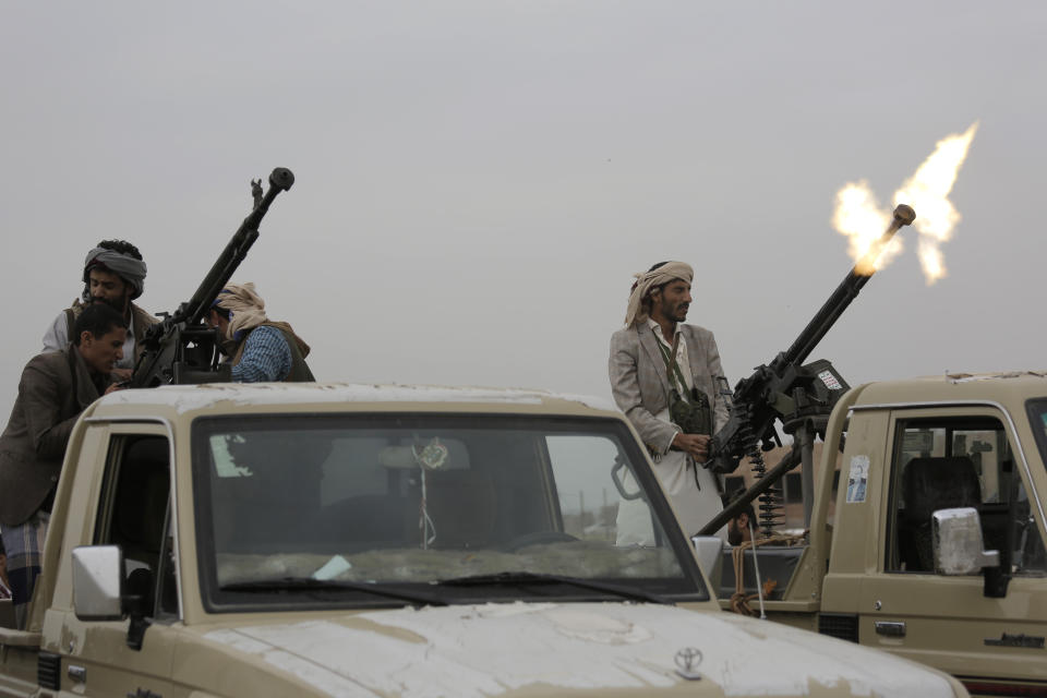 FILE - In this Aug. 1, 2019 file photo, a Houthi fighter fires in the air during a gathering aimed at mobilizing more fighters for the Houthi movement, in Sanaa, Yemen. Houthi rebels have blocked half of the United Nations’ aid delivery programs in the war-torn country — a strong-arm tactic to force the agency to give them greater control over the massive humanitarian campaign, along with a cut of billions of dollars in foreign assistance, according to aid officials and internal documents obtained by The Associated Press. (AP Photo/Hani Mohammed, File)