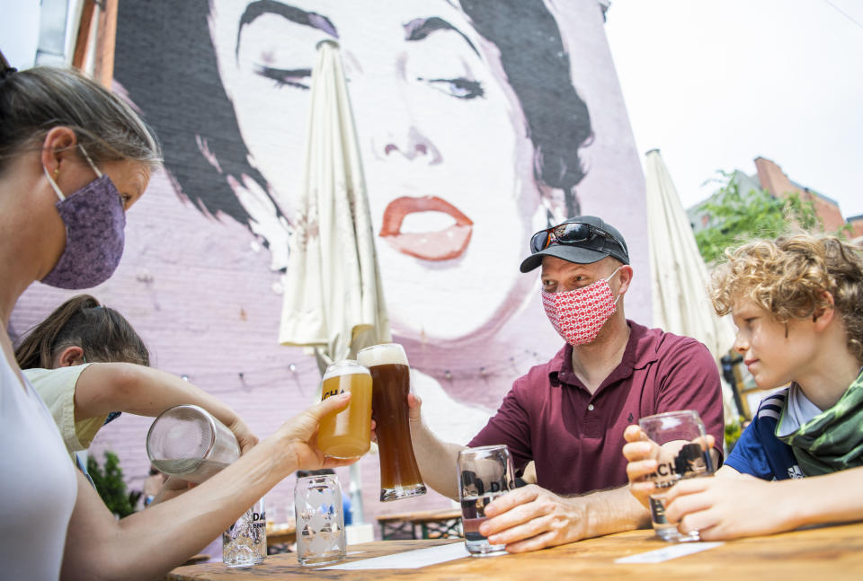 UNITED STATES - MAY 29: James Wedekind and his wife, Jessica, of Springfield, Va., sit with their children at Dacha Beer Garden in the Shaw neighborhood on the first day of the phase one reopening of Washington, D.C., on Friday, May 29, 2020. Washington has lifted the stay-at-home order that was in place due to the COVID-19 pandemic and allowed certain businesses to reopen. (Photo By Tom Williams/CQ-Roll Call, Inc via Getty Images)