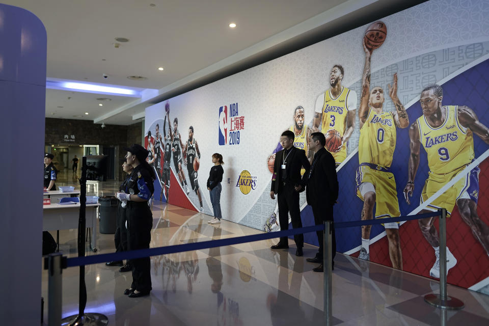 Security personnel wait for spectators to arrive at a checkpoint to an NBA preseason game to be held at the Mercedes Benz Arena in Shanghai, China, Thursday, Oct. 10, 2019. All media events such as news conferences have been canceled inside the arena hosting Thursday's NBA preseason game in China between the Los Angeles Lakers and Brooklyn Nets, though the matchup itself remains on as scheduled. (AP Photo)