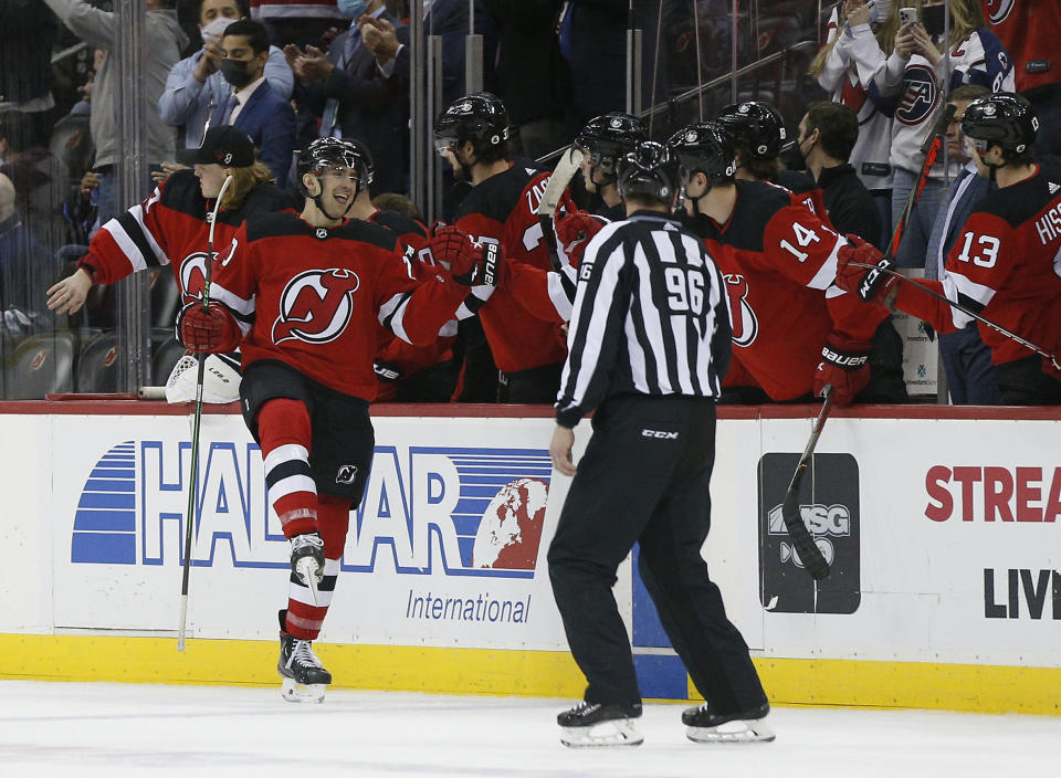 New Jersey Devils center Michael McLeod, left, celebrates after scoring a goal against the Carolina Hurricanes during the second period of an NHL hockey game, Saturday, Jan. 22, 2022, in Newark, N.J. (AP Photo/Noah K. Murray)