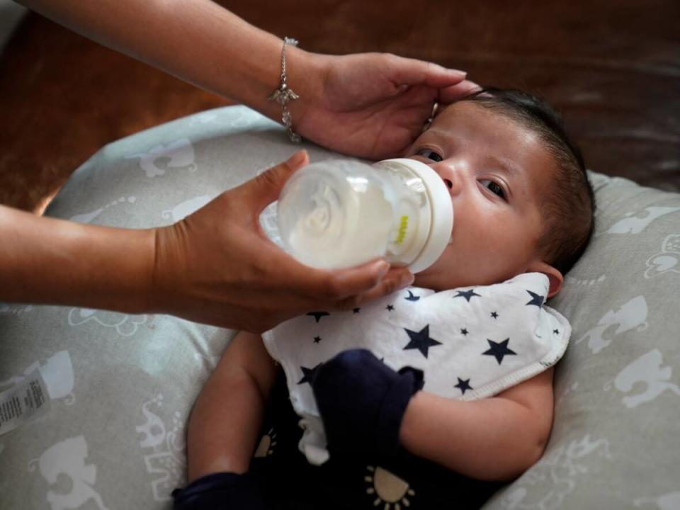 A mother feeds her infant son in San Antonio, Texas, on Friday. A shortage of baby formula across the U.S. has forced parents to go to significant lengths to feed their children. (Eric Gay/The Associated Press - image credit)