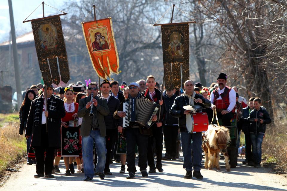 A Bulgarian Orthodox priest leads an open air mass as part of the celebrating of the wine feast called St.Trifon day in the village of Brestovica, 80 miles east of the capital Sofia Saturday, Feb. 14, 2015.