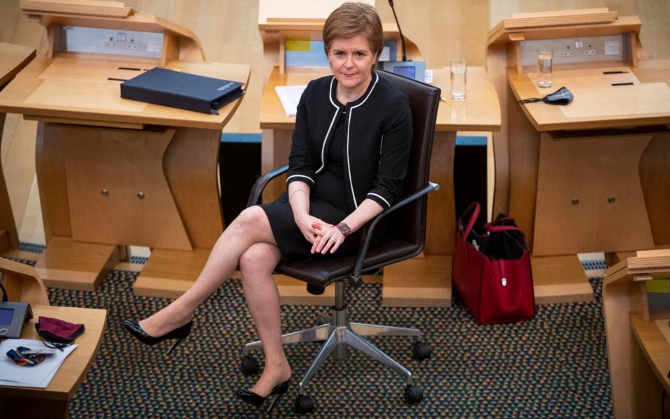 Scotland's First Minister Nicola Sturgeon sits in the main chamber - JANE BARLOW/AFP