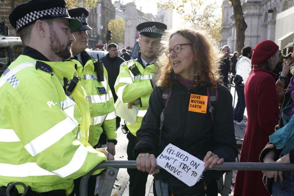 A protester glues he hand to a fence outside Downing Street as part of a civil disobedience by Extinction Rebellion. Activists are calling on the government to act to turnaround environmental policy as part of a week of coordinated actions. (Extinction Rebellion)