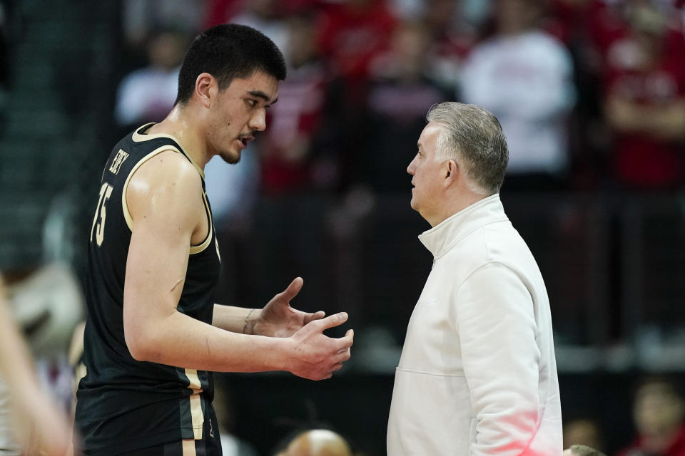 Purdue's Zach Edey (15) talks with Purdue coach Matt Painter during the first half of an NCAA college basketball game against Wisconsin Sunday, Feb. 4, 2024, in Madison, Wis. (AP Photo/Andy Manis)