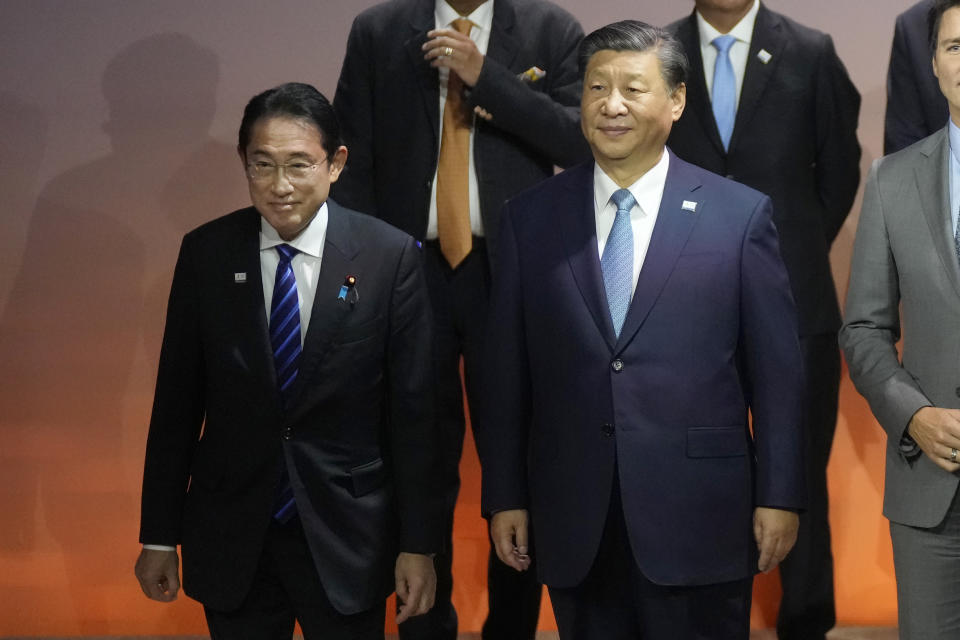 Japan's Prime Minister Fumio Kishida, left, stands next to Chinese President Xi Jinping during the family photo at the APEC Summit in San Francisco, Thursday, Nov. 16, 2023. (AP Photo/Jeff Chiu)
