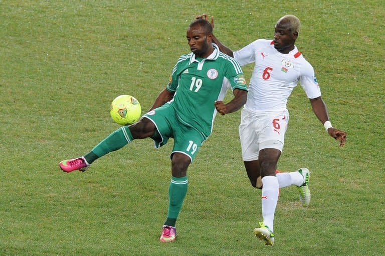 Nigeria forward Sunday Mba (left) is challenged by Burkina Faso midfielder Djakaridja Kone during the 2013 Africa Cup of Nations final on February 10, 2013 at Soccer City stadium in Johannesburg. A first-half goal from Mba saw Nigeria to a third Africa Cup of Nations title as they beat Burkina Faso 1-0