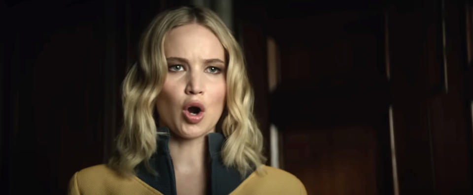 Jennifer Lawrence delivers an intense expression in a scene from the movie "Don't Look Up," wearing a jacket with a high collar